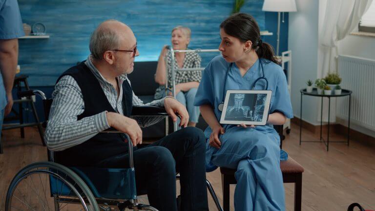 woman-nurse-with-x-ray-tablet-showing-scan-old-patient-768x432